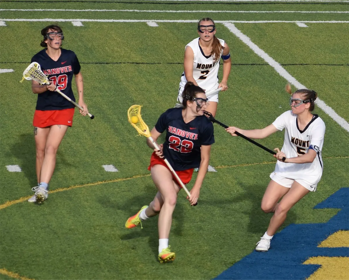 Hanover Women's Lacrosse player running with ball 